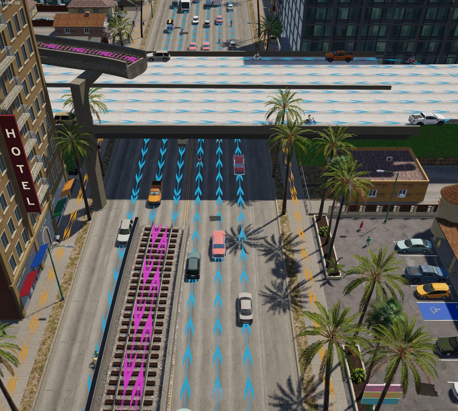 Looking down on a wide road with lane arrows, a centre divider and a rail line